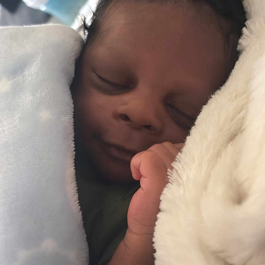 Alijah is registered to the contest to win money with this photo: baby, blanket, bottle, child, closeup, cozy, cuddle, face, hand, indoors, infant, newborn, nursery, peaceful, portrait, resting, sleeping, soft, warm, wrapped