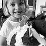 child, smiling, indoor, stuffed_toy, plush, horse, happy, portrait, short_hair, white_shirt, toy, cute, young, person, face, holding, living_room, furniture, black_and_white, closeup