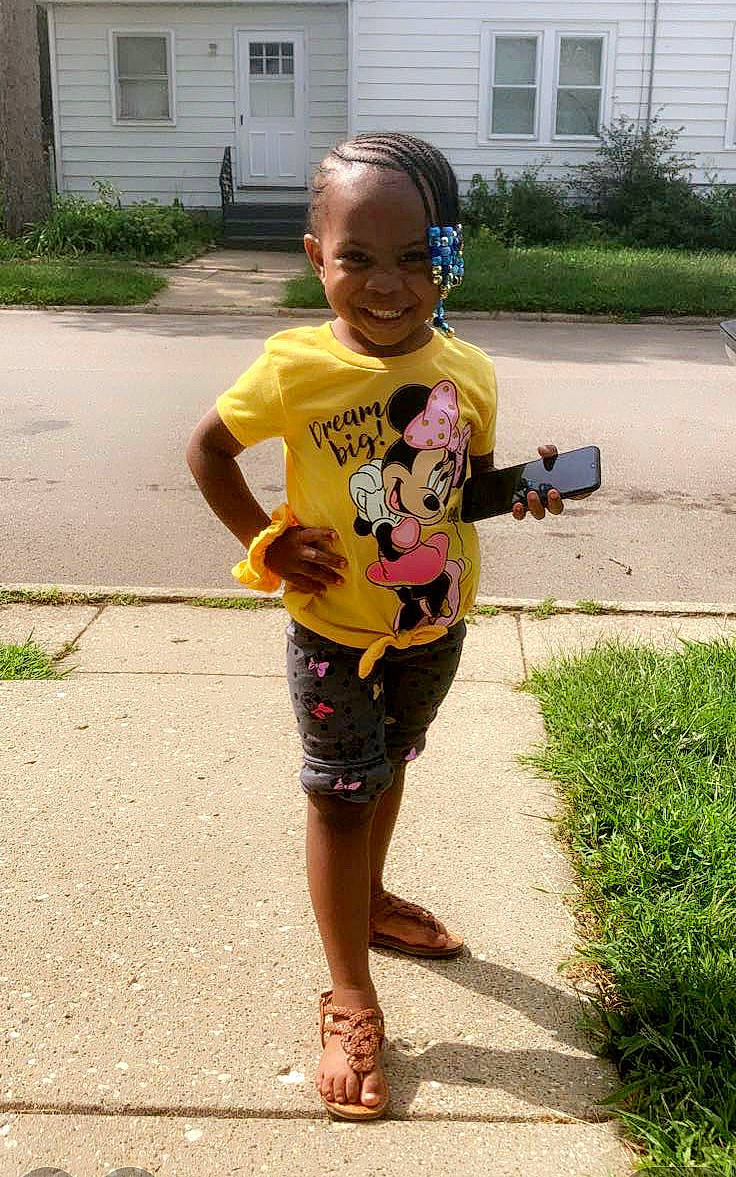 Amirah joined the competition — help win amazing prizes! asphalt, child, door, eyewear, flip_flops, fun, grass, hair, head, joy, leisure, person, plant, recreation, sandal, shorts, sidewalk, smile, t_shirt, thigh