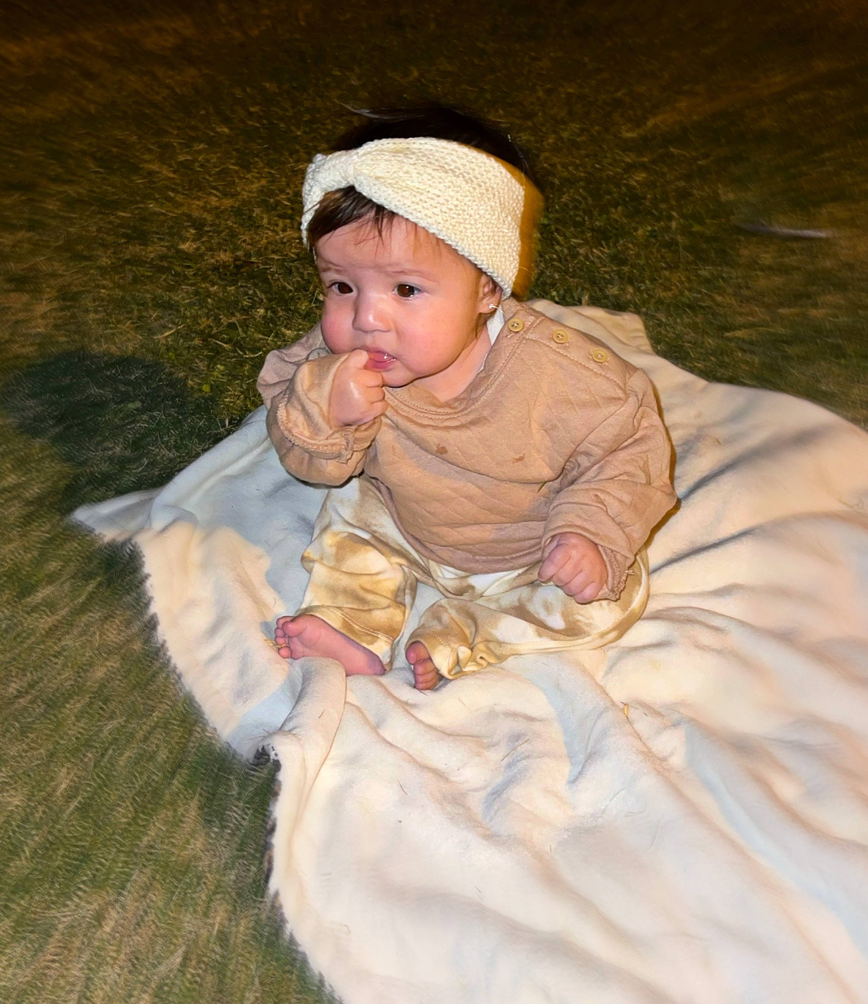 Alaina joined the competition — help win amazing prizes! art, baby, baby_toddler_clothing, cap, cheek, costume_hat, dress, eye, face, fashion_accessory, grass, hat, head, headwear, human_body, leaf, person, plant, sitting, toddler