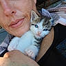 person, kitten, cat, blue_eyes, close_up, selfie, holding, cute, animal, pet, indoor, face, skin, freckles, clothing, scarf, hand, fur, expression, portrait