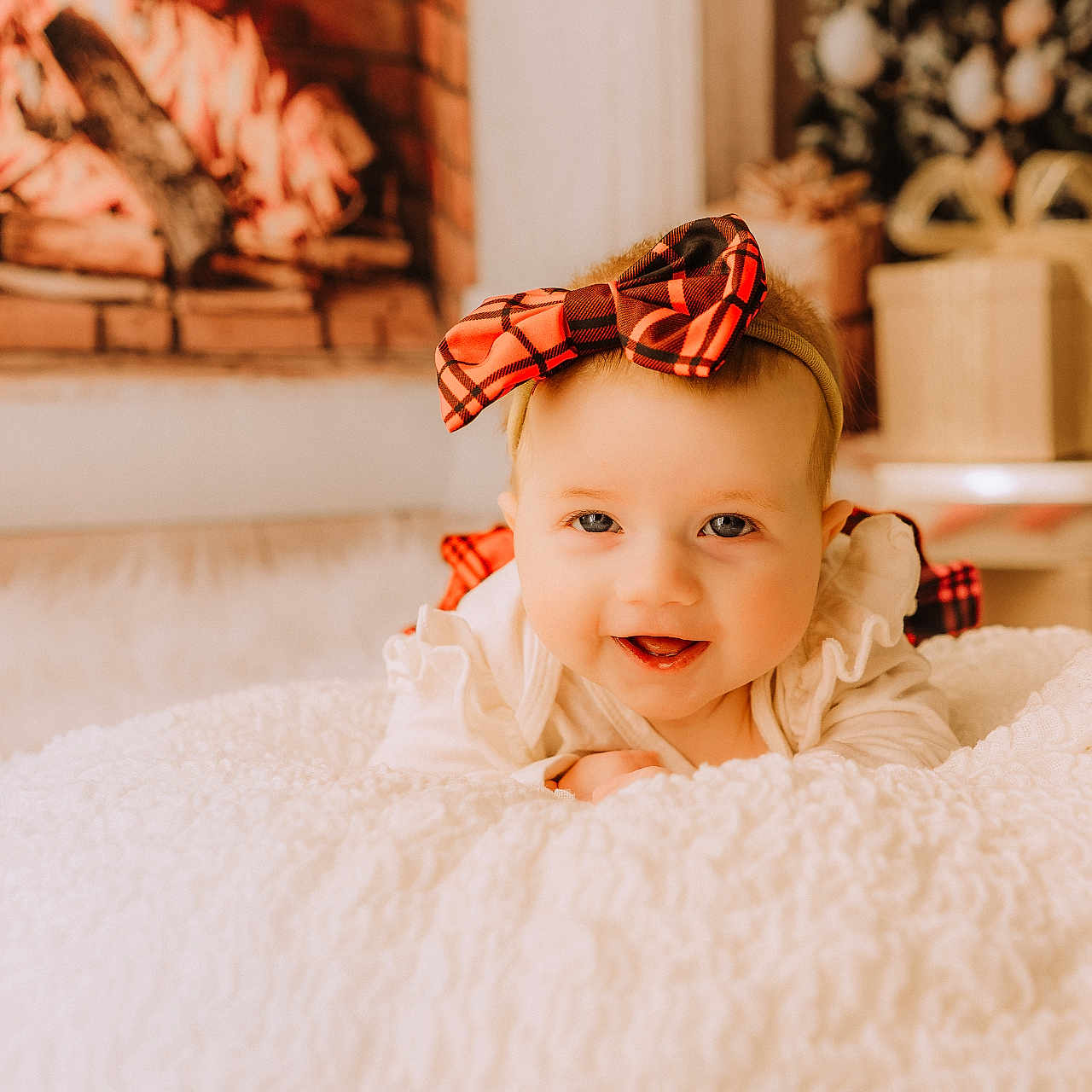 Melody is registered to the contest to win money with this photo: accessories, baby, babylaughing, blanket, blonde, clothing, crawling, dress, face, happy, head, headband, indoors, laughing, newborn, person, photography, portrait, sitting, smile