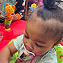 Nylayah joined the competition — help win amazing prizes! child, toddler, baby, toy, bottle, pacifier, play_area, colorful, curly_hair, clothing, indoor, person, face, sitting, playtime, feeding, furniture, bright_colors, cute, young