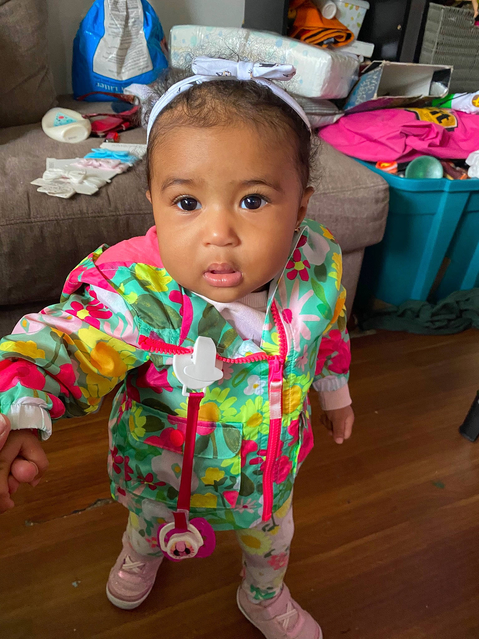 Juliet is registered to the contest to win money with this photo: baby, baby_toddler_clothing, cheek, child, dress, face, hair_accessory, head, headgear, neck, person, pink, play, sitting, skin, smile, toddler