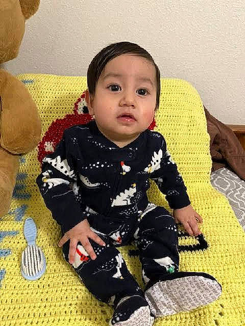 Jeremiah is registered to the contest to win money with this photo: baby, baby_toddler_clothing, cheek, child, comfort, flooring, fun, happy, head, iris, pattern, person, sitting, skin, sleeve, sock, toddler