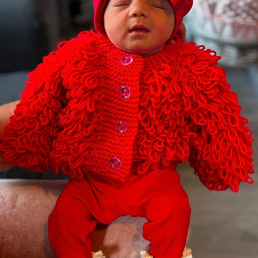 Alarming-Mae joined the competition — help win amazing prizes! baby, blurred_background, bow, buttoned_sweater, child, comfortable, cozy, cute, fashion, headwear, indoor, infant, knitted_sweater, lace_trim, portrait, red_outfit, resting, sleeping, soft_chair, white_socks