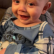Rowan joined the competition — help win amazing prizes! baby, child, smiling, face, blue_clothing, pajamas, plaid, happy, indoor, closeup, skin, person, head, eyes, mouth, infant, cute, comfort, sitting, warmth