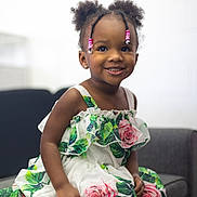 Yara joined the competition — help win amazing prizes! child, girl, smile, dress, flowers, beads, hair, braids, couch, indoor, portrait, happy, cute, fashion, sitting, young, person, skin, apparel, furniture
