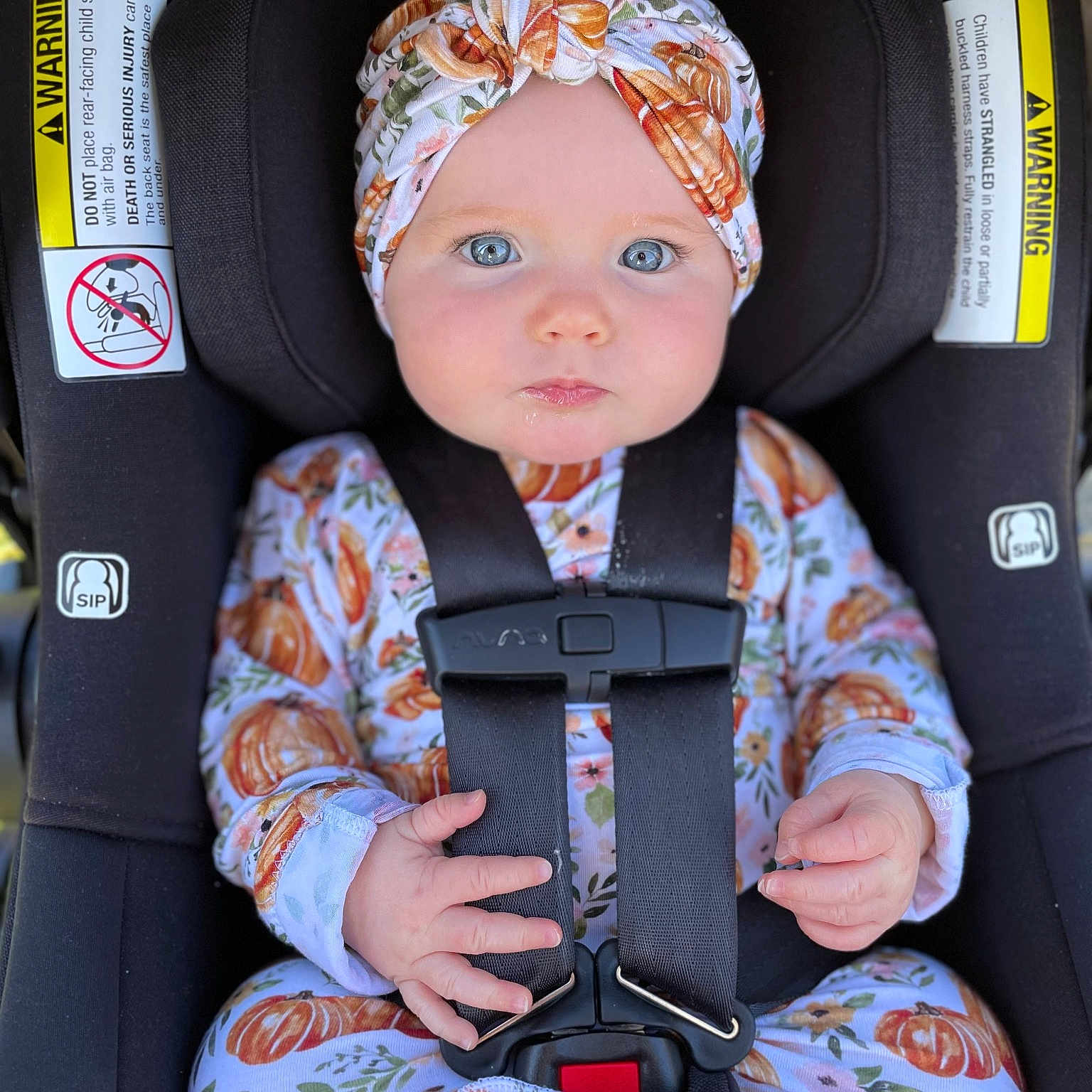 Mila is registered to the contest to win money with this photo: auto_part, baby, baby_carriage, baby_in_car_seat, baby_products, baby_toddler_clothing, bag, cap, car_seat, car_seat_cover, child, costume_hat, fashion_accessory, outerwear, personal_protective_equipment, product, seat_belt, sitting, textile, toddler