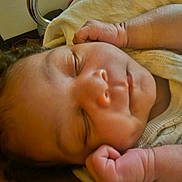 Dhoryian is registered to the contest to win money with this photo: baby, bed, blanket, closeup, comfort, cozy, curly_hair, face, fist, hand, indoors, infant, newborn, peaceful, person, resting, skin, sleeping, soft, stroller