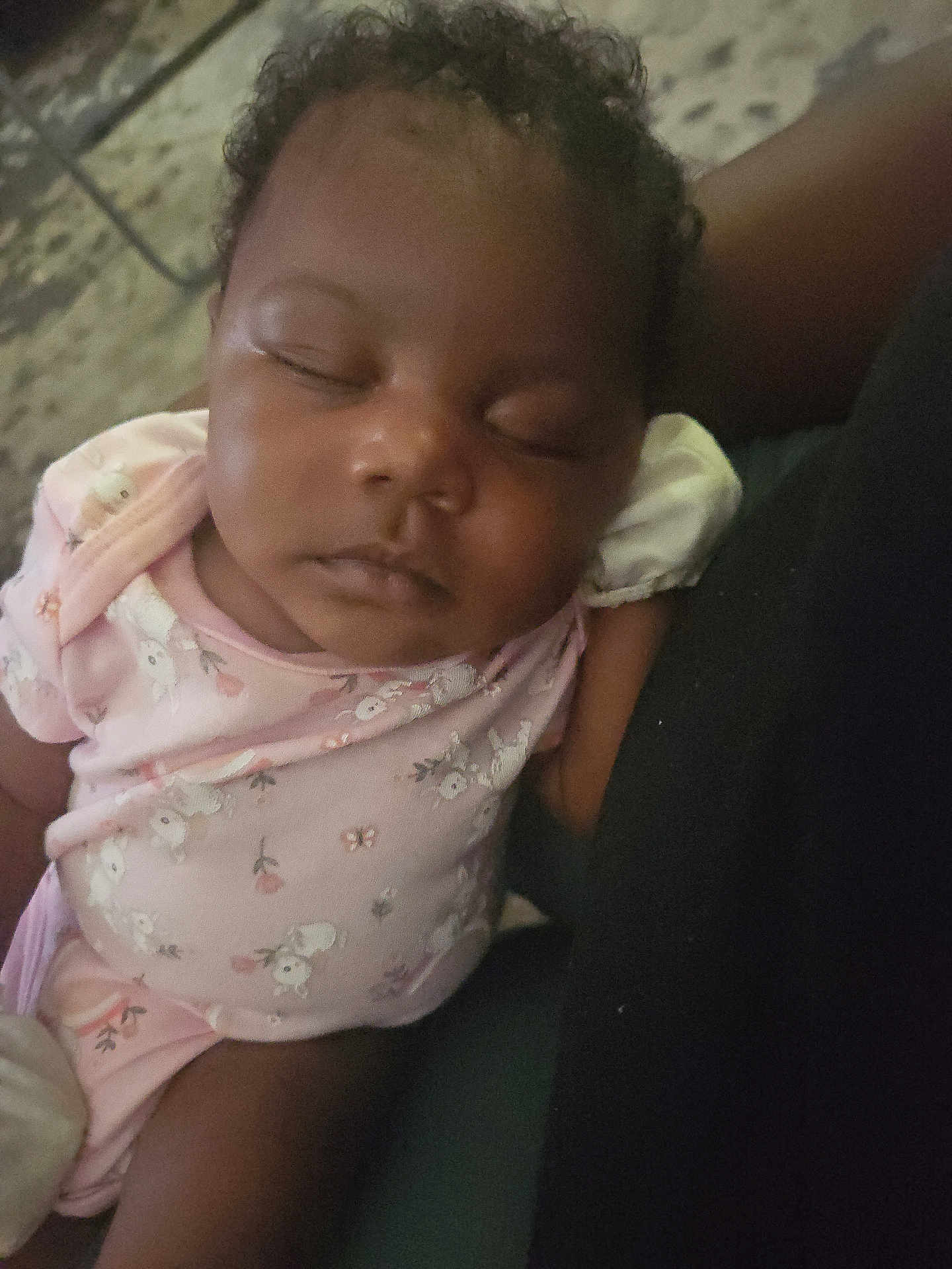 Dhoryian is registered to the contest to win money with this photo: baby, sleeping, curly_hair, infant, pink_clothing, onesie, person, closeup, peaceful, resting, child, indoor, arm, toddler, cute, young_child, portrait, skin, face, relaxation