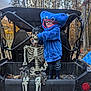 Jacobi is registered to the contest to win money with this photo: child, costume, hoodie, monster, skeleton, gloves, bandana, off_road_vehicle, forest, trees, autumn, leaves, outdoor, person, blue, smile, toy, playful, nature, fun