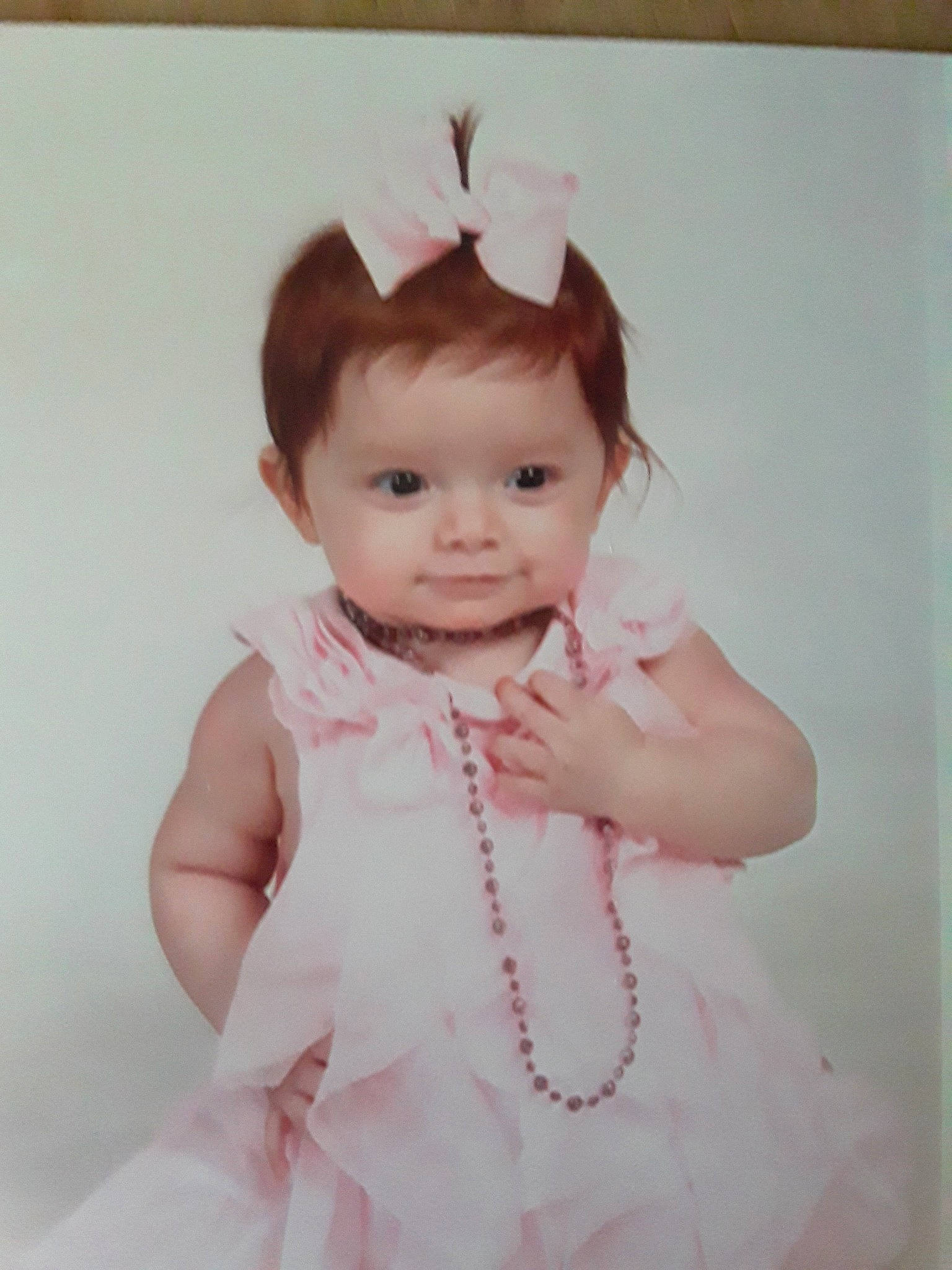 Nevaeha is registered to the contest to win money with this photo: baby, cheek, child, face, forehead, hair_accessory, head, person, pink, portrait, skin, smile, toddler