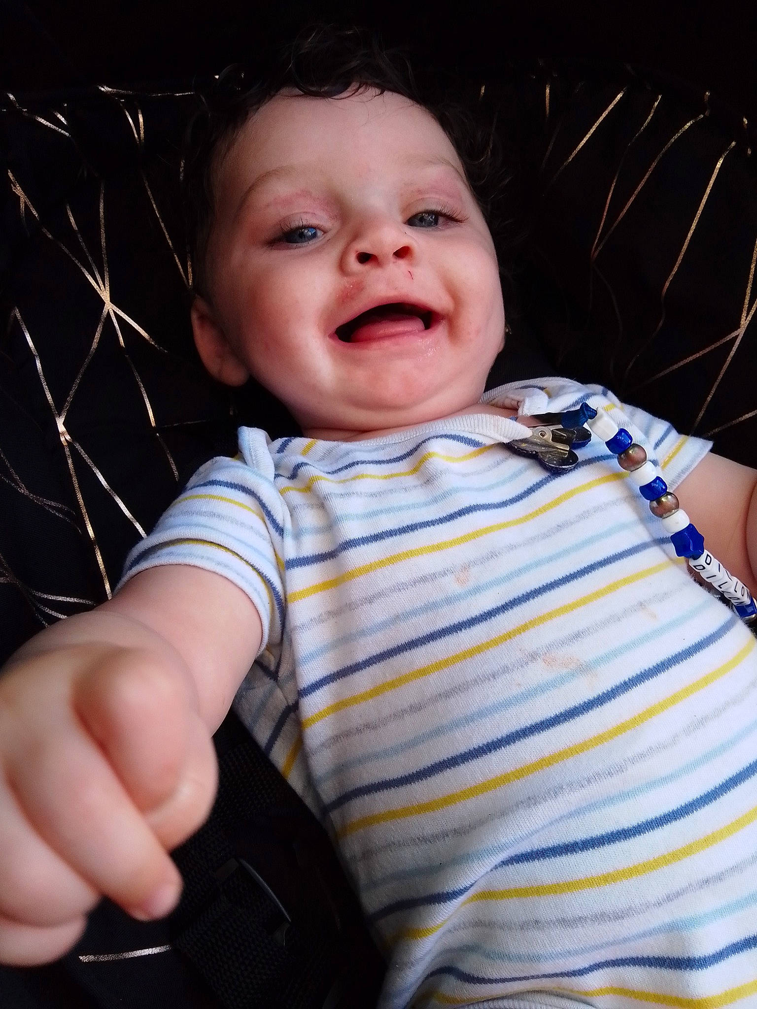 Dillon is registered to the contest to win money with this photo: arm, baby_toddler_clothing, cheek, chin, eye, eyebrow, face, finger, flash_photography, happy, human_body, iris, joy, lip, mouth, nose, person, product, skin, sleeve