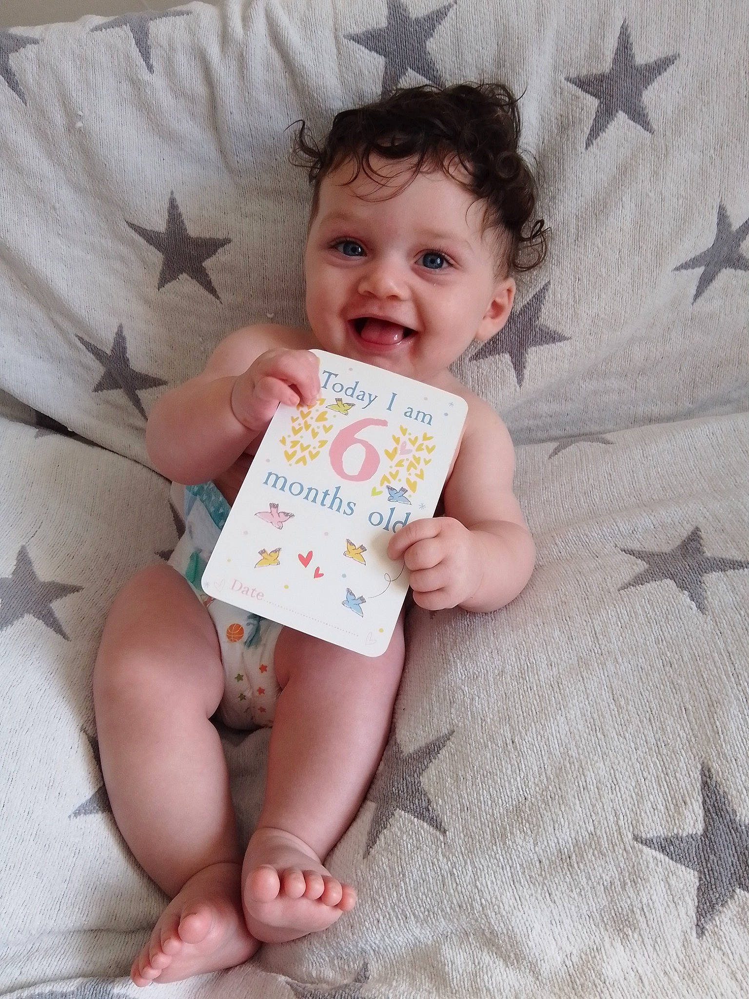 Dillon is registered to the contest to win money with this photo: baby_toddler_clothing, cheek, chin, eye, face, facial_expression, finger, hair, hand, happy, head, nose, organ, person, pink, product, skin, sleeve, smile, textile