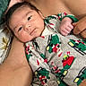 Ayden is registered to the contest to win money with this photo: arm, baby, child, closeup, clothing, comfort, fabric, face, festive, hand, holiday, indoor, infant, onesie, pattern, person, portrait, resting, skin, tender