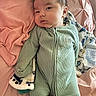 baby, infant, onesie, blanket, pink, green, face, lying_down, bottle, plush, soft, cute, child, baby_bottle, bed, sleepwear, indoors, person, young, resting