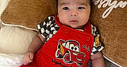 Ayden joined the competition — help win amazing prizes! baby, bed, blanket, child, clothing, comfort, cute, expression, hand, indoors, infant, lightning_mcqueen, looking, person, pillow, portrait, red_overalls, resting, soft_fabric, young