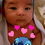 Ayden is registered to the contest to win money with this photo: baby, infant, face, towel, wrapped, cute, closeup, cartoon_overlay, hearts, stitch_character, child, portrait, skin, expression, indoors, newborn, adorable, looking, young, love