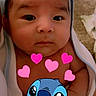 baby, infant, face, towel, wrapped, cute, closeup, cartoon_overlay, hearts, stitch_character, child, portrait, skin, expression, indoors, newborn, adorable, looking, young, love