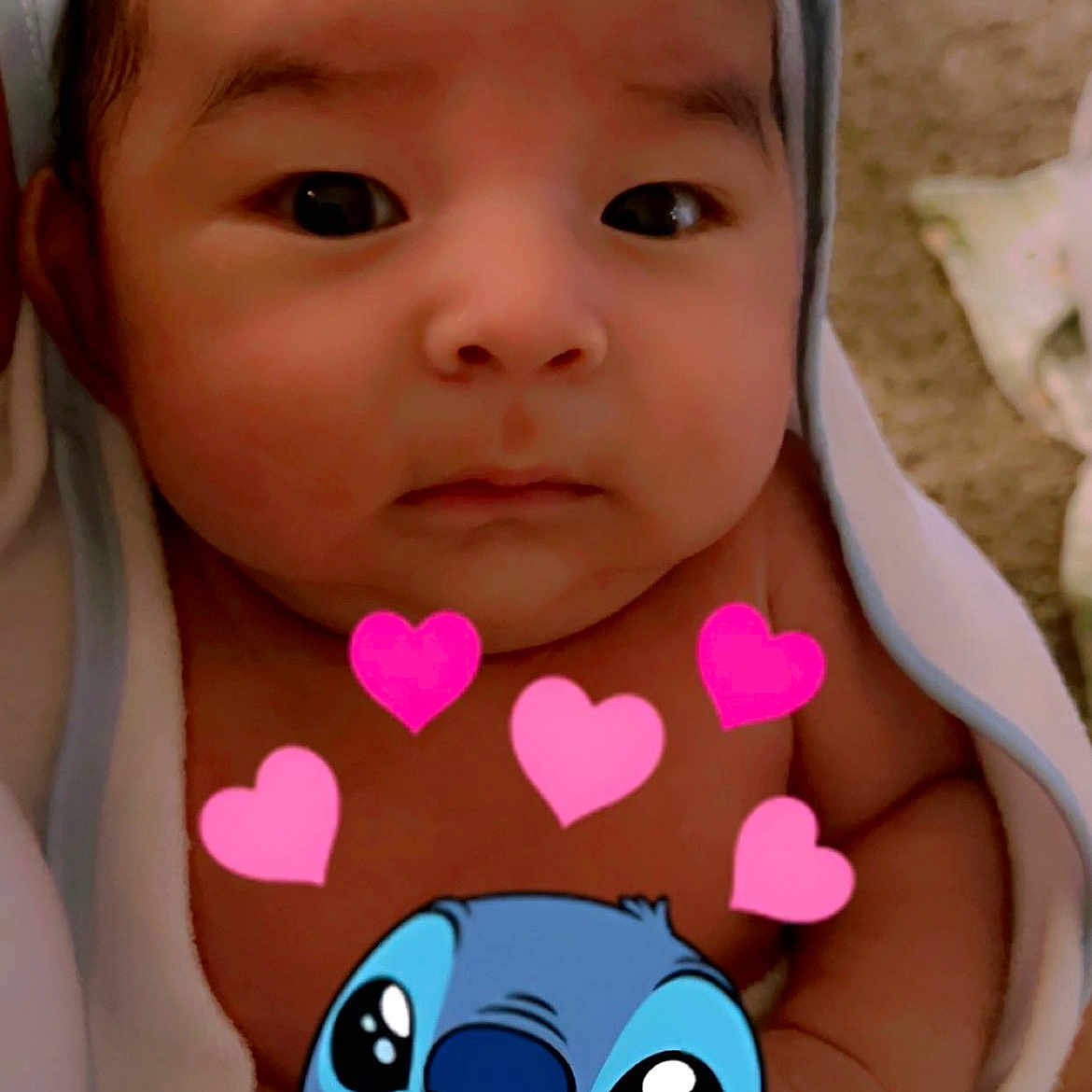 Ayden is registered to the contest to win money with this photo: baby, infant, face, towel, wrapped, cute, closeup, cartoon_overlay, hearts, stitch_character, child, portrait, skin, expression, indoors, newborn, adorable, looking, young, love