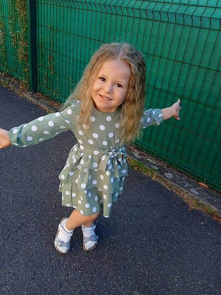 Amelia a rejoint le concours — aidez-le/la à gagner de superbes lots ! baby_toddler_clothing, child, dress, electric_blue, eye, fence, fun, grass, hair, hand, happy, head, human_body, joy, mesh, pattern, people_in_nature, person, pink, recreation