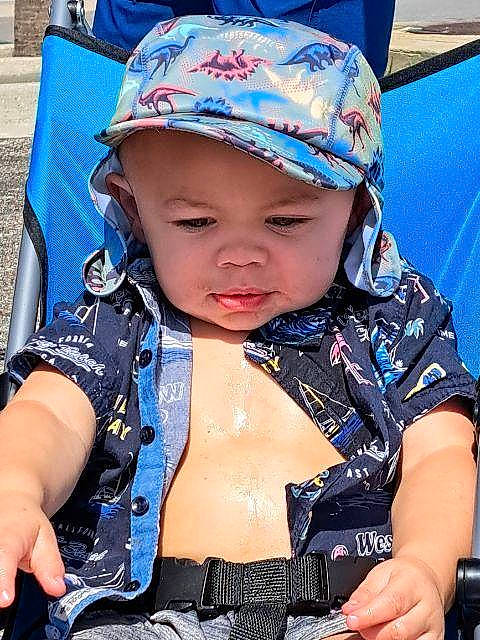 Justin is registered to the contest to win money with this photo: baby, baby_carriage, baby_products, baby_toddler_clothing, baseball_cap, blue, cap, child, electric_blue, fashion_accessory, fun, happy, hat, headgear, headwear, person, personal_protective_equipment, public_space, purple, recreation