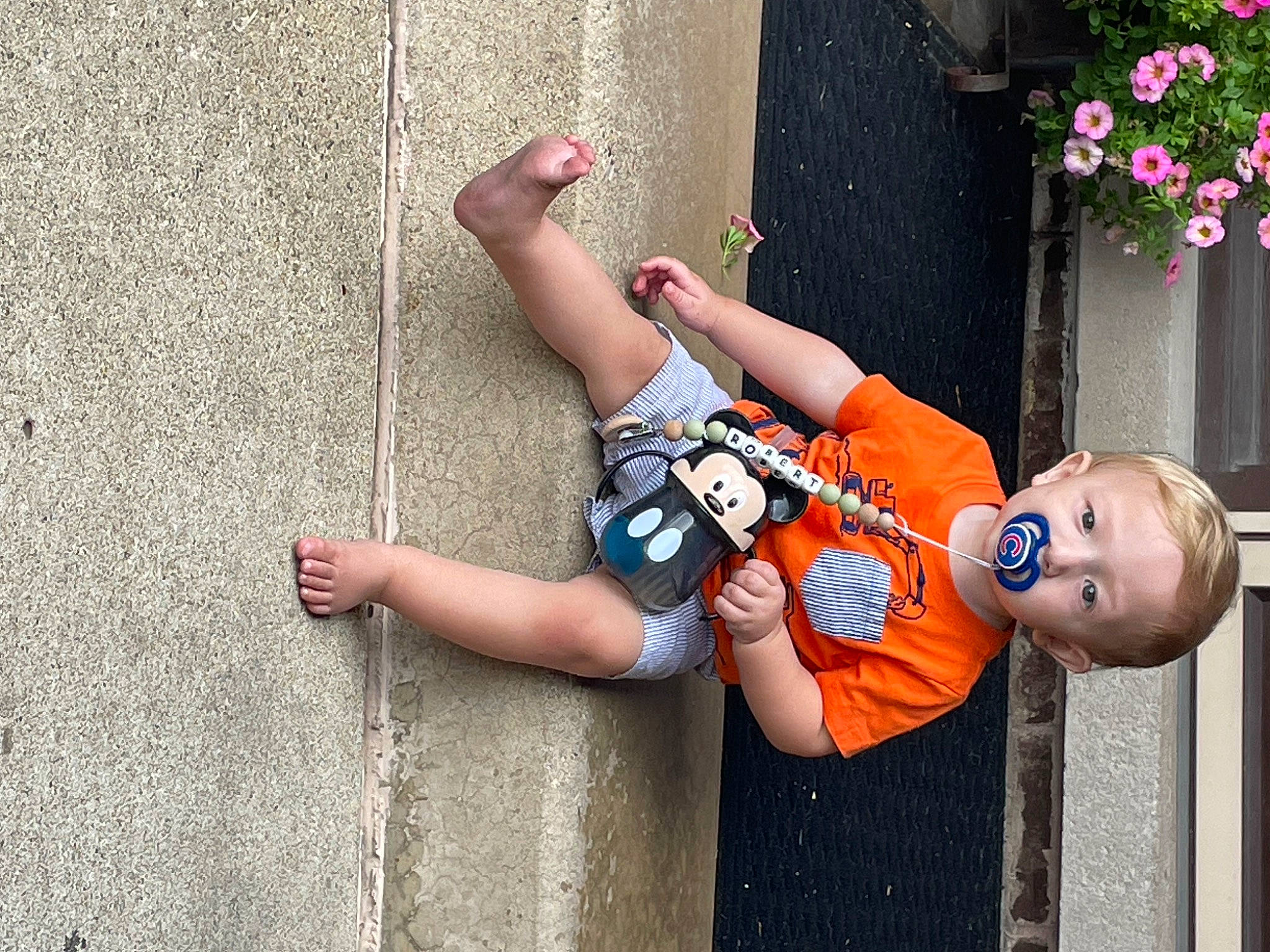 Robert is registered to the contest to win money with this photo: art, child, concrete, elbow, flower, fun, happy, human_leg, joint, leisure, person, plant, recreation, street, toddler, toy, tree