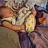 baby, blanket, sleeping, foot, sock, winnie_the_pooh, bed, bedding, child, cozy, cute, indoor, person, soft_texture, resting, colorful, cartoon, sleep, infant, clothing