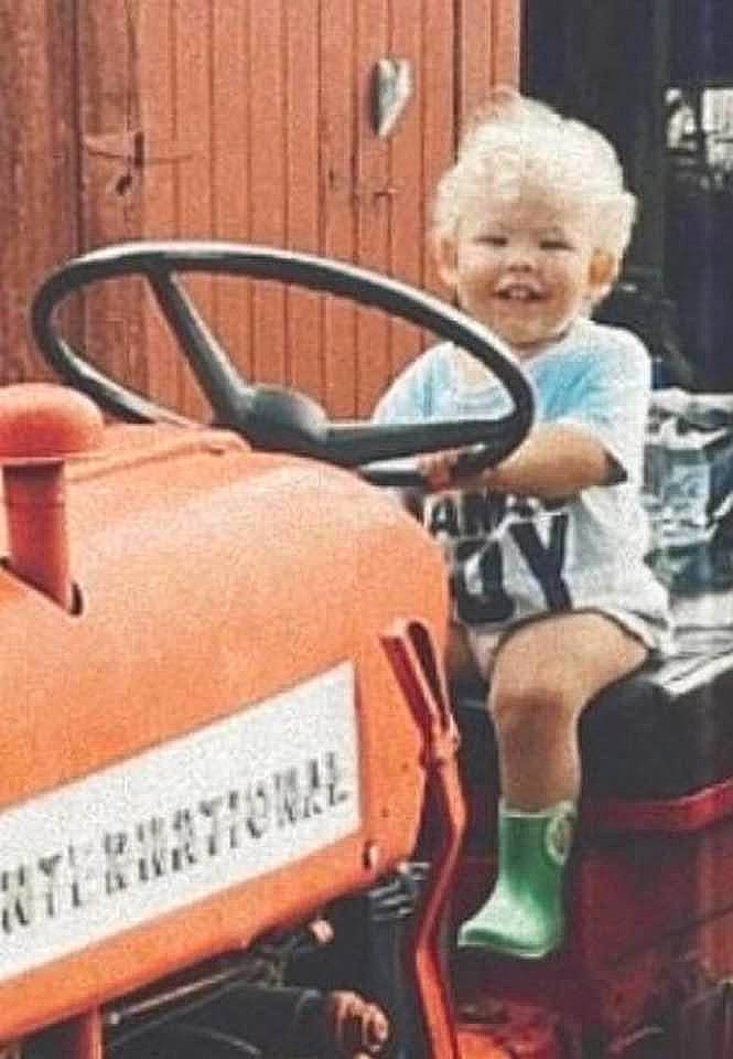 Cash is registered to the contest to win money with this photo: auto_part, automotive_exterior, automotive_window_part, baby_toddler_clothing, classic, family_car, fender, font, happy, joy, machine, motor_vehicle, person, riding_toy, sitting, smile, steering_wheel, toddler, tractor, vehicle