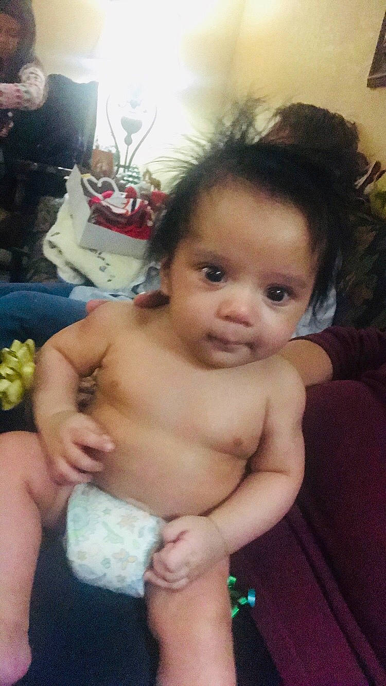 Edison is registered to the contest to win money with this photo: abdomen, black_hair, cheek, child, chin, face, finger, forehead, girl, hand, head, human_hair_color, infant, iris, leg, mouth, nose, person, skin, toddler