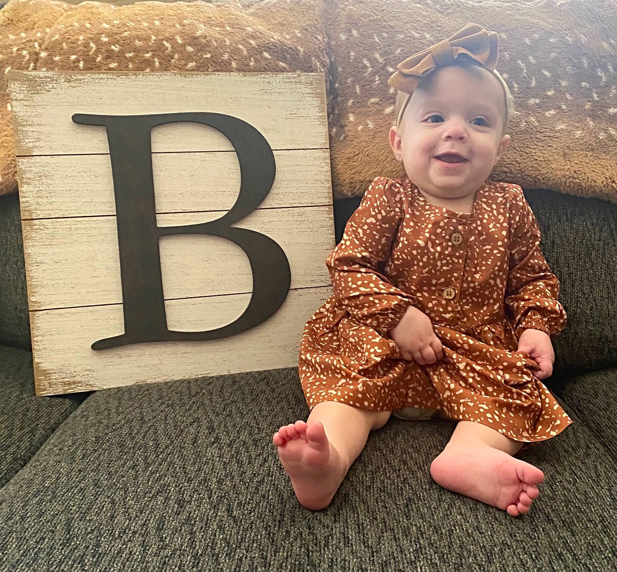 Baylee joined the competition — help win amazing prizes! baby, baby_toddler_clothing, barefoot, child, cool, facial_expression, floor, flooring, font, foot, happy, human_leg, joy, pattern, person, sitting, skin, sleeve, smile, standing