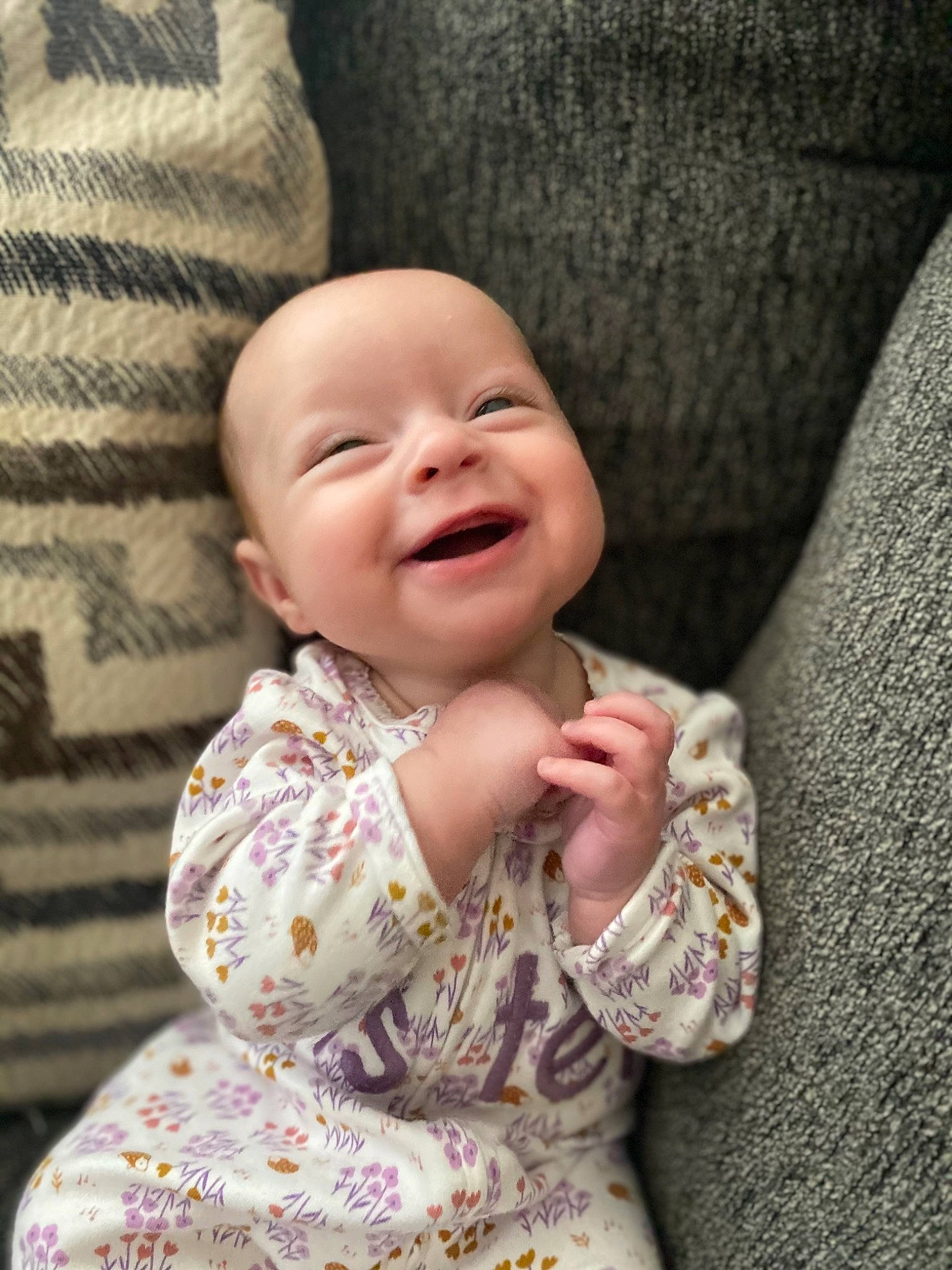 Brynlee is registered to the contest to win money with this photo: arm, baby, baby_toddler_clothing, cheek, comfort, dress, eye, face, facial_expression, gesture, happy, head, iris, joy, lip, nose, outerwear, person, skin, sleeve