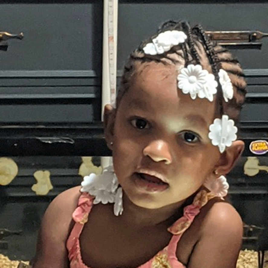 Saneea joined the competition — help win amazing prizes! braided_hair, cabinet, child, curious, cute, expression, face, flower_clips, furniture, girl, hair_accessory, home, indoor, measurement_tape, person, pink_dress, portrait, sitting, sticker, young_child