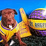 dog, pit_bull, lakers, basketball, foam_finger, jersey, los_angeles, purple_yellow, sports_fan, studio_backdrop, blue_background, closeup, portrait, paws, ears, eyes, grass_rug, toy_ball, mascot, fan