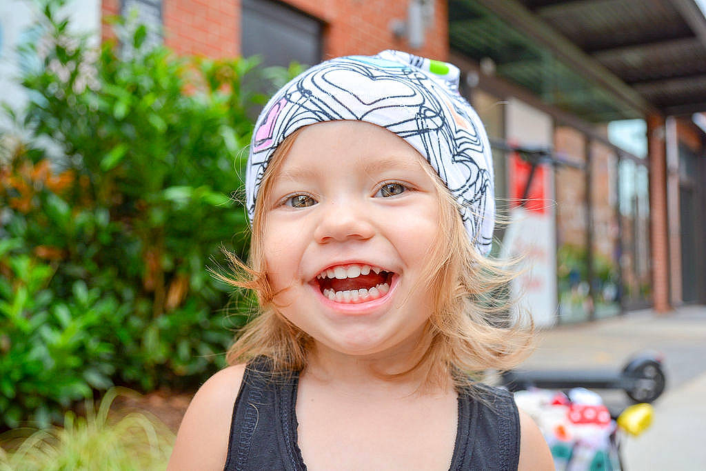 Edith is registered to the contest to win money with this photo: beanie, cap, child, clothing, ear, face, facial_expression, fun, hair_accessory, happy, head, headgear, joy, laugh, lip, person, skin, smile, summer, toddler