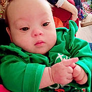 Imari-Lynn joined the competition — help win amazing prizes! baby, child, christmas, close_up, couch, cozy, cute, decorations, face, festive, green_clothing, hands, holiday, home, indoor, infant, person, portrait, red_couch, young_child