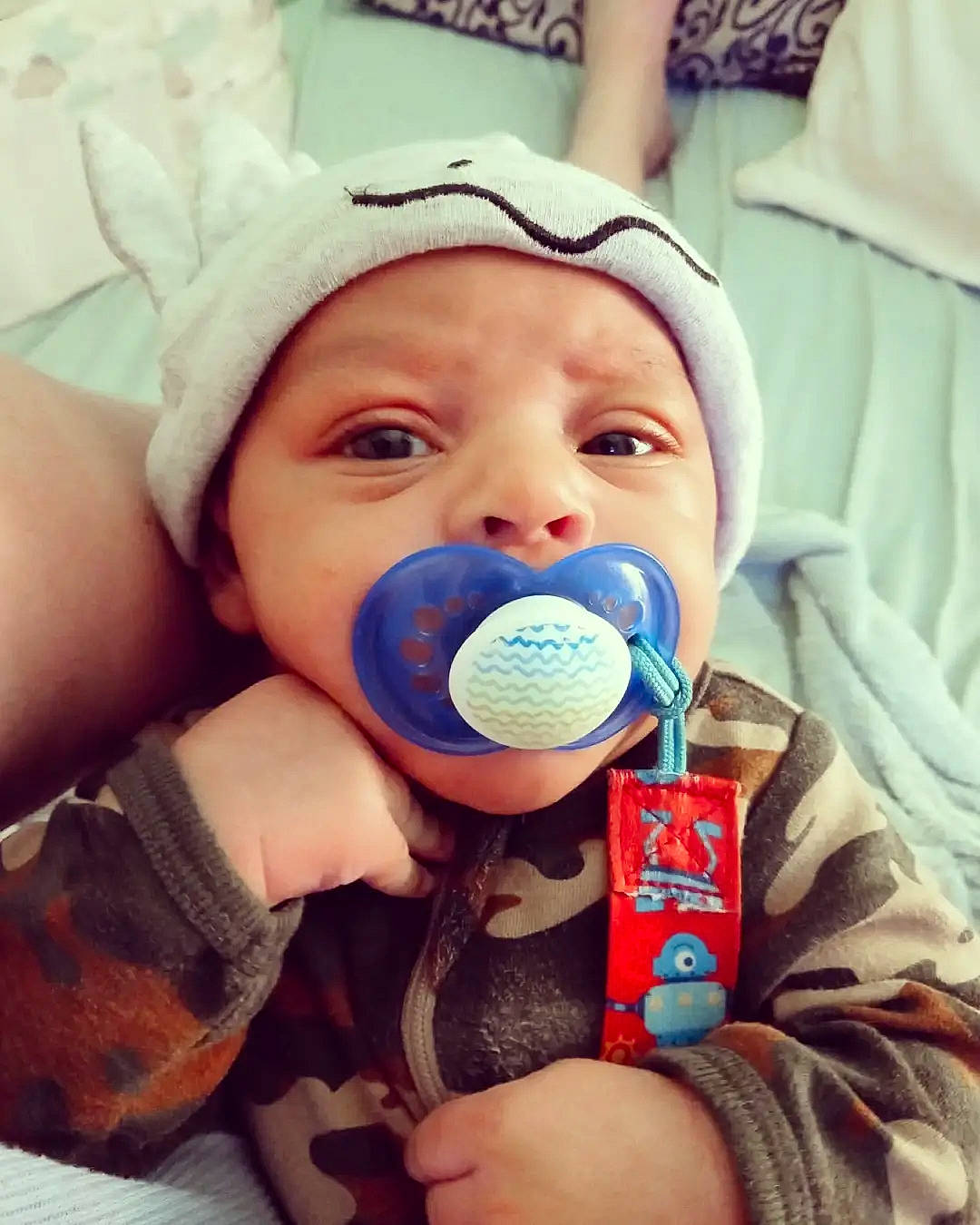 Liam is registered to the contest to win money with this photo: audio_equipment, baby, baby_toddler_clothing, cap, cheek, child, comfort, electronic_device, eyelash, finger, gadget, hand, happy, headwear, microphone, nail, nose, person, product, skin