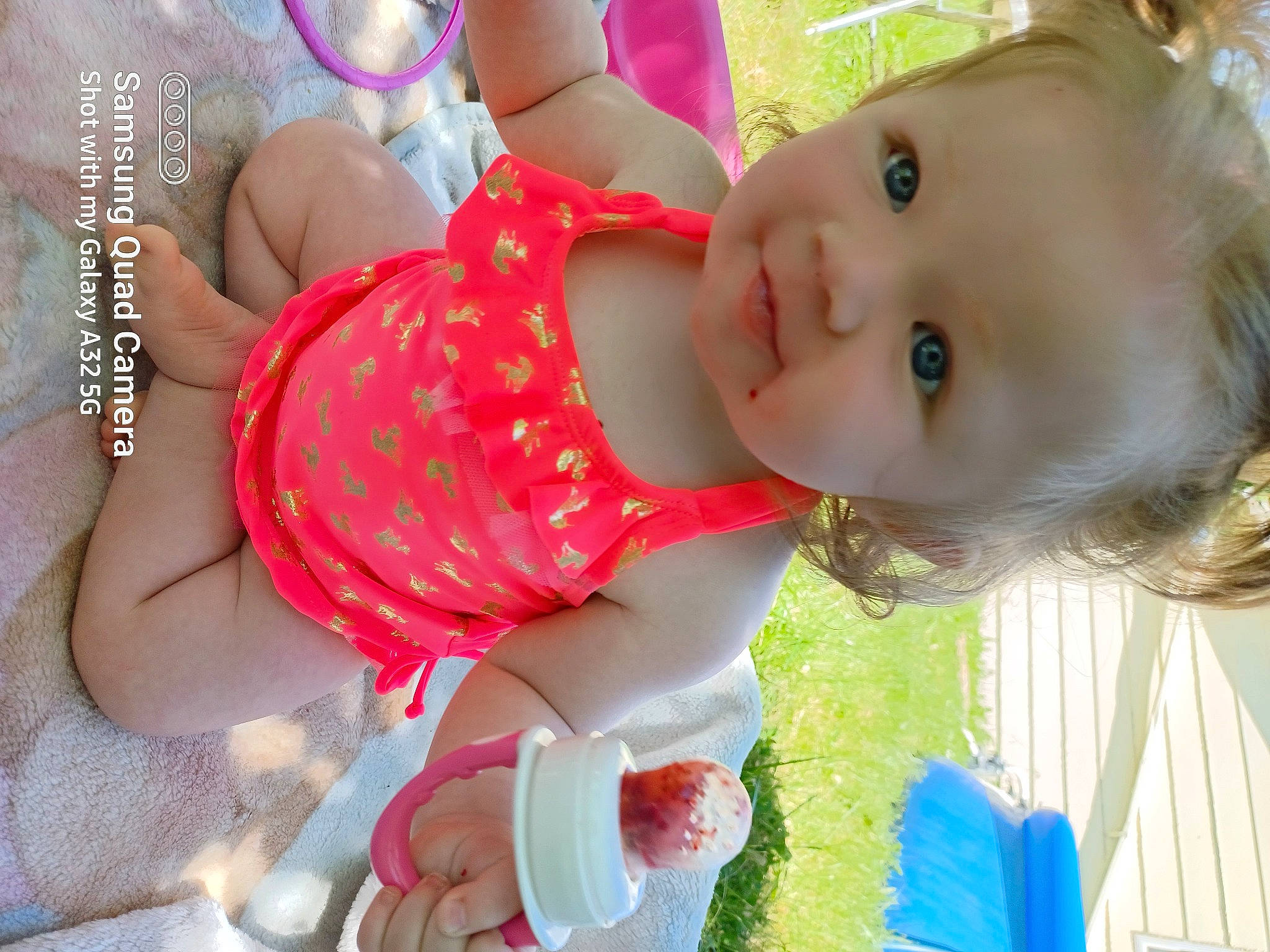 Evie joined the competition — help win amazing prizes! baby, baby_products, baby_toddler_clothing, cheek, chest, child, finger, fun, grass, green, happy, jewellery, nail, pattern, person, pink, skin, smile, toddler, white