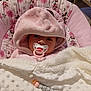 baby, baby_chair, beads, blanket, child, comfort, cute, face, hood, indoor, infant, minnie_mouse, pacifier, pink_clothing, portrait, resting, sleepwear, soft_texture, toy, wrapped