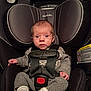 Madeline is registered to the contest to win money with this photo: baby, infant, newborn, car_seat, harness, buckle, sweater, knit_pants, socks, headrest, seat_padding, safety_label, straps, face, eyes, portrait, indoors, hands, feet, seat