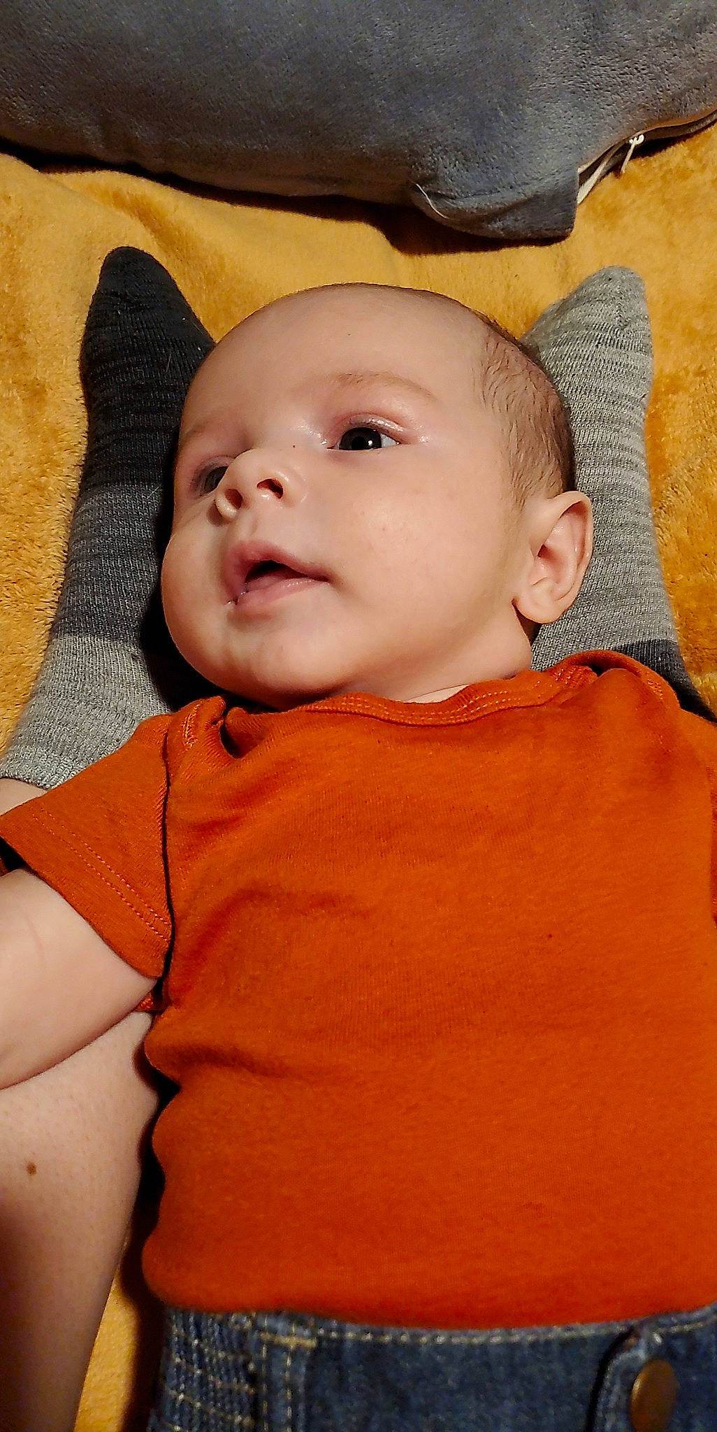 Cillian is registered to the contest to win money with this photo: baby, baby_toddler_clothing, cheek, chin, collar, comfort, eye, eyebrow, happy, headgear, human_body, iris, lip, mouth, neck, nose, orange, person, skin, sleeve