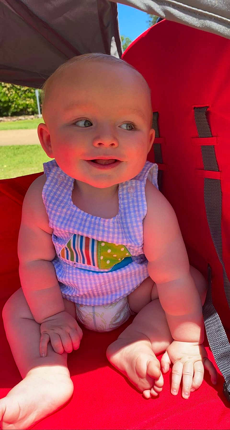 Win is registered to the contest to win money with this photo: baby, baby_toddler_clothing, cheek, face, facial_expression, happy, head, human, human_body, iris, leg, lip, mouth, nose, orange, person, pink, plant, skin, smile