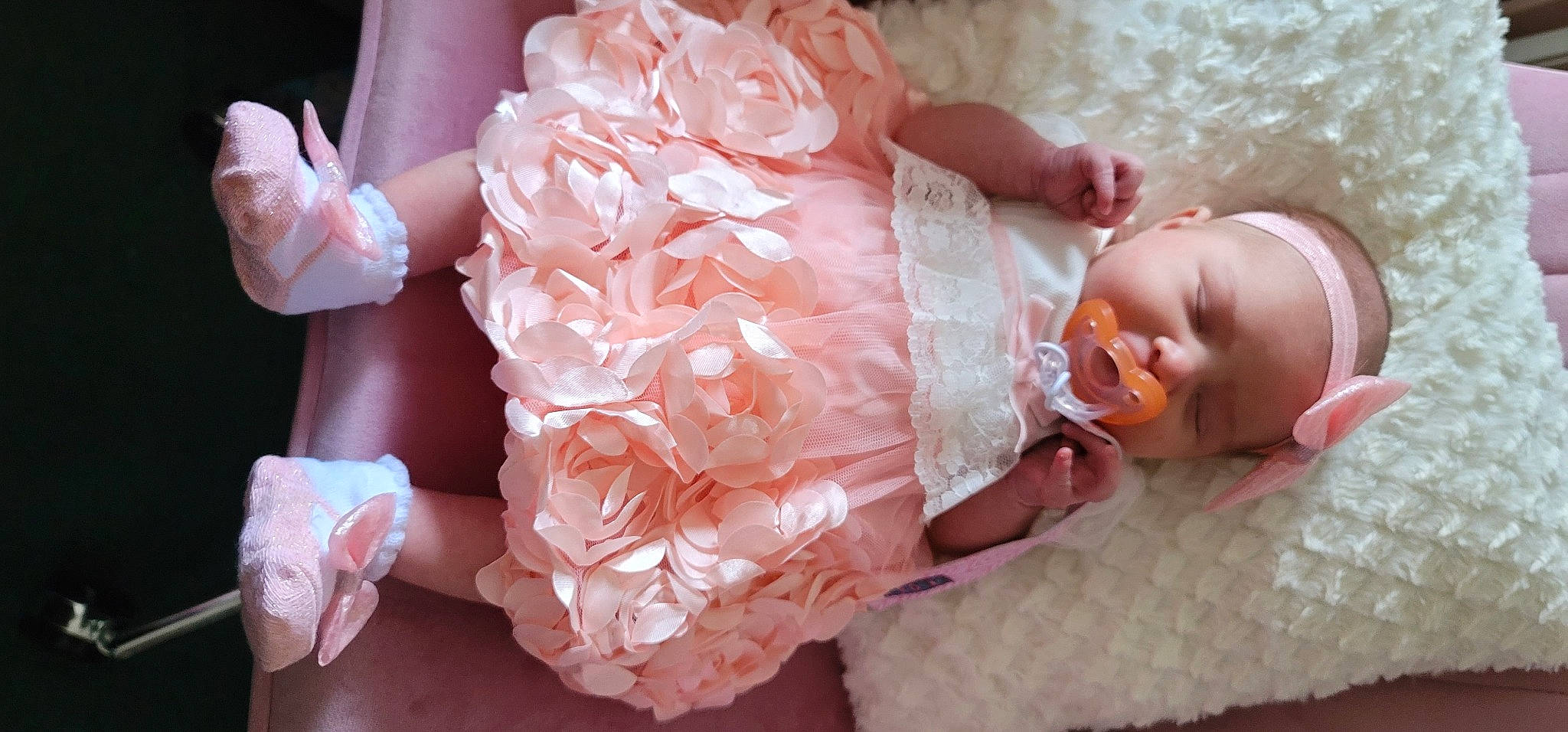 Shaylynn joined the competition — help win amazing prizes! baby, baby_sleeping, baby_toddler_clothing, bridal_accessory, child, comfort, dress, embellishment, flower_arranging, happy, headgear, headpiece, headwear, orange, peach, person, petal, pink, plant, textile