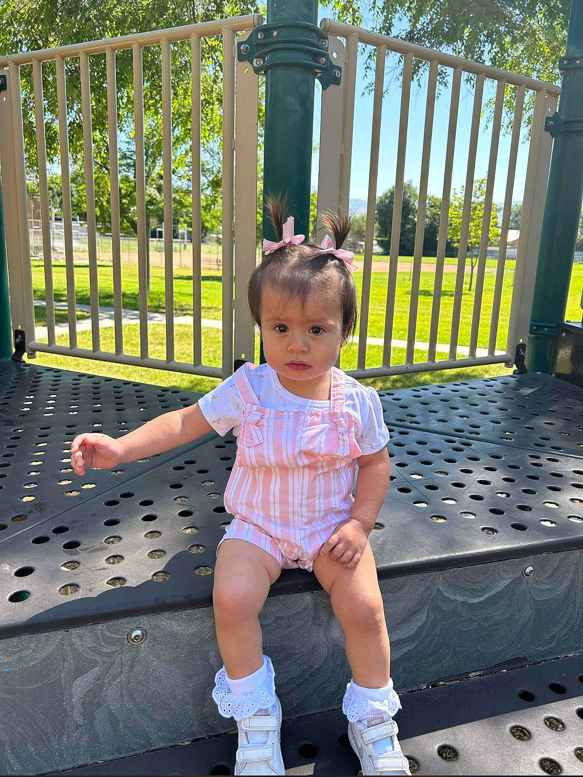 Nahomi joined the competition — help win amazing prizes! baby_toddler_clothing, child, city, fence, fun, grass, green, happy, human_leg, leisure, line, person, plant, recreation, sandal, shorts, sitting, toddler, tree, vacation