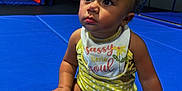 Kenzleigh joined the competition — help win amazing prizes! baby, bib, blue_mat, child, clothing, curious, cute, expression, face, floor, hand, indoor, legs, looking_up, play_area, polka_dot, sitting, skin, toddler, yellow_bow