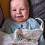 Albie joined the competition — help win amazing prizes! baby, smiling, blanket, blue_onesie, cushion, yellow_cushion, gray_cushion, infant, face, happy, indoors, child, cute, cozy, pacifier, soft_texture, portrait, resting, comfort, baby_clothing
