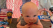 Larkin joined the competition — help win amazing prizes! american_flag, baby, background, celebration, child, cute, decorations, face, festive, happy, holiday, indoor, patriotic, portrait, red_white_blue, smiling, stars, striped_clothing, toy, tummy_pose