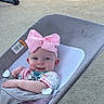 baby, baby_girl, baby_rocker, child, colorful_clothing, comfort, cute, fabric, happy, headband, infant, outdoor, pink_bow, playful, portrait, relaxing, seated, smile, sunlight, young_child