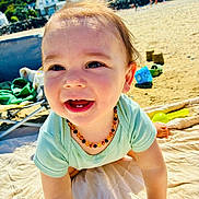 Léyo participe au concours pour gagner de l'argent avec cette photo : baby, beach, blanket, child, clothing, crawling, cute, daytime, happy, nature, necklace, outdoor, person, play, portrait, sand, smiling, sunlight, toddler, toys